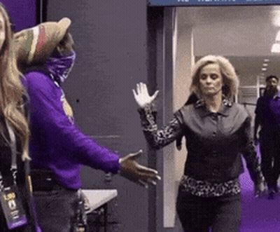 Woman In Purple Shirt Waving To Man In Purple Shirt GIF