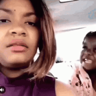 Woman In Purple Shirt With Little Girl In Car GIF