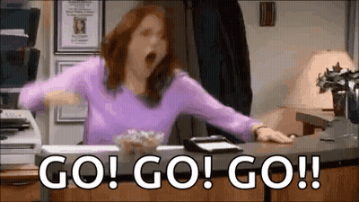 Woman In Purple Shirt Yawning At Desk GIF