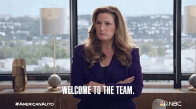 Woman In Purple Suit Standing With Arms Crossed Saying Welcome To The Team GIF