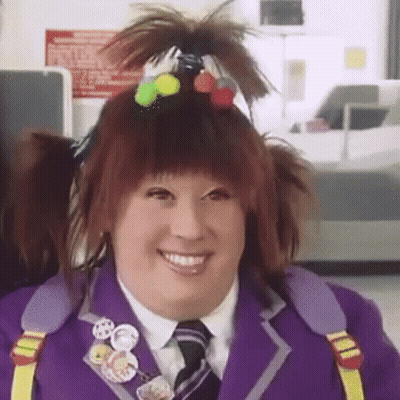 Woman In Purple Suit Tie Ponytail Smiling GIF