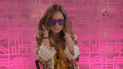 Woman In Purple Sunglasses In Front Of Pink Wall GIF