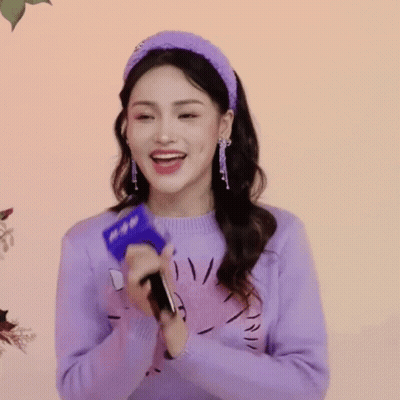 Woman In Purple Sweater And Headband Holding Microphone GIF
