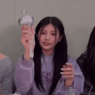 Woman In Purple Sweater Holding Light Stick GIF