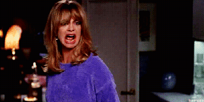 Woman In Purple Sweater Making Funny Face GIF