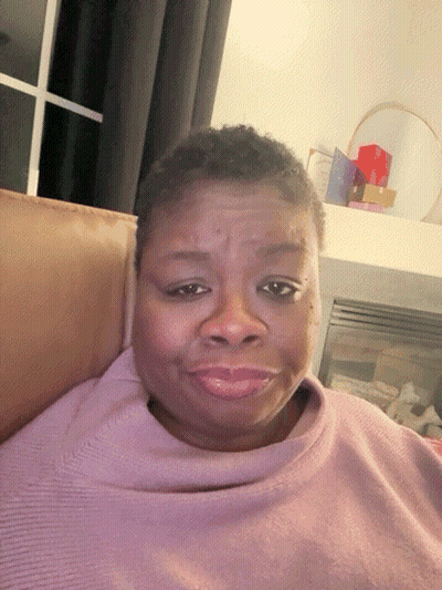 Woman In Purple Sweater Sitting On Couch GIF