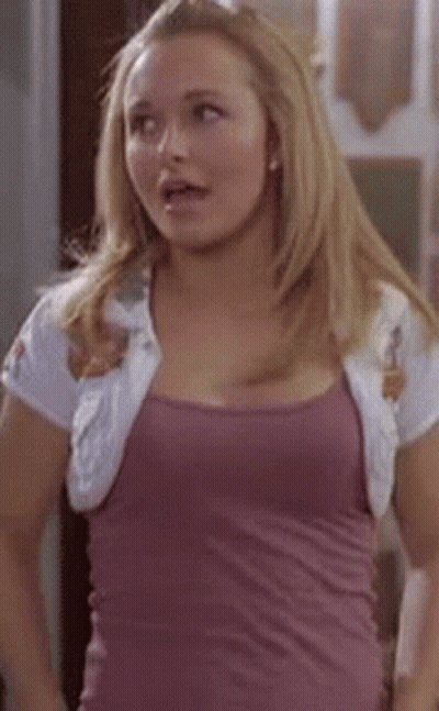 Woman In Purple Tank Top And White Jacket Standing In Room GIF