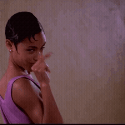Woman In Purple Tank Top Pointing Finger Up GIF