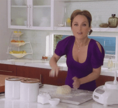 Woman In Purple Top Kneading Dough GIF