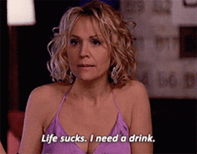 Woman In Purple Top Saying Life Sucks I Need A Drink GIF