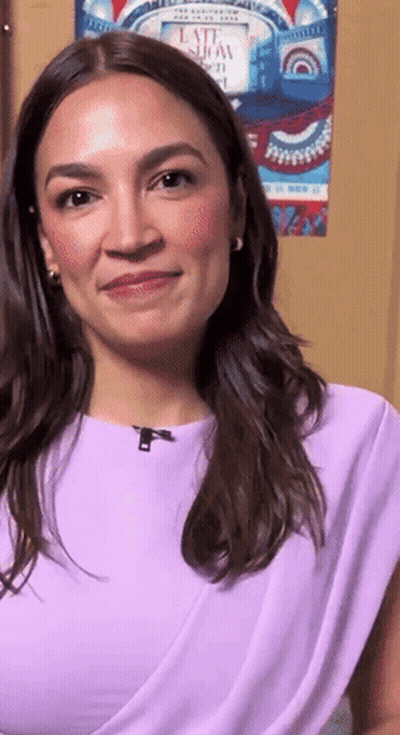Woman In Purple Top Smiling In Front Of Late Show Poster GIF