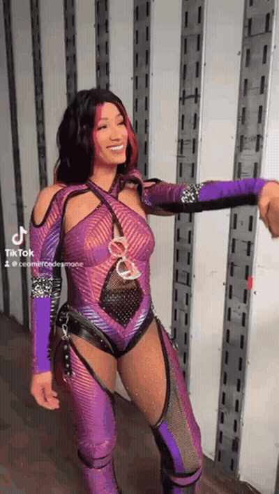 Woman In Purple Wrestling Outfit Shaking Hands With Man In Truck GIF