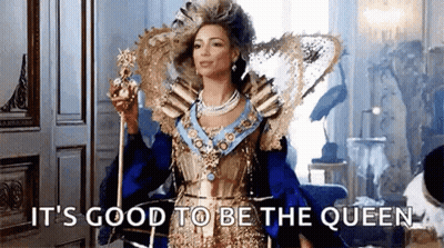Woman In Queen Costume Holding Crown And Scepter GIF