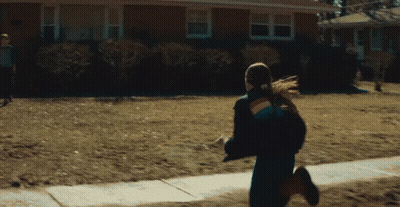 Woman in Rainbow Jacket Running