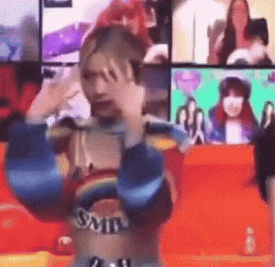 Woman In Rainbow Top Making Funny Face At Screen GIF