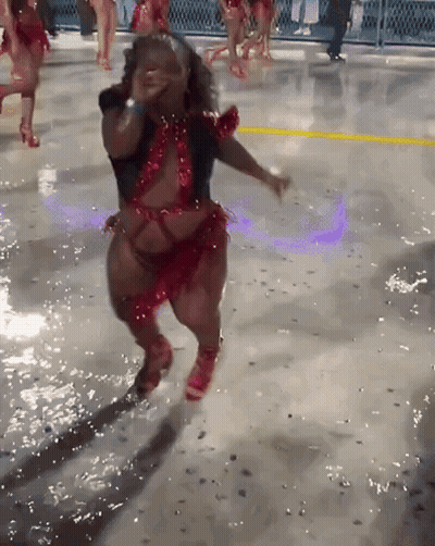 Woman In Red And Black Dancing On Wet Surface GIF