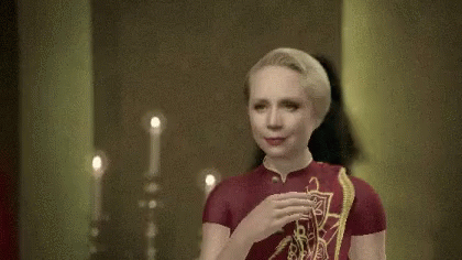 Woman In Red And Gold Celtic Dress GIF