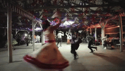 Woman In Red And White Dress Dancing In Crowd GIF
