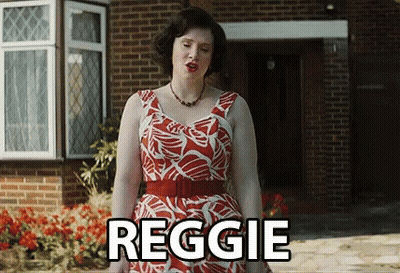 Woman In Red And White Dress In Front Of Brick House Saying Reggie GIF