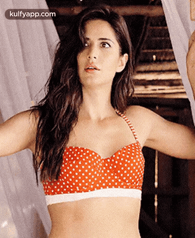 Woman In Red And White Polka Dot Bikini Top By Window GIF