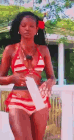 Woman In Red And White Striped Bikini On Balcony GIF