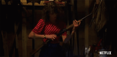 Woman In Red And White Striped Shirt Holding Shotgun GIF