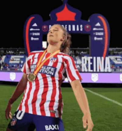 Woman In Red And White Striped Shirt With Medal On Soccer Field GIF