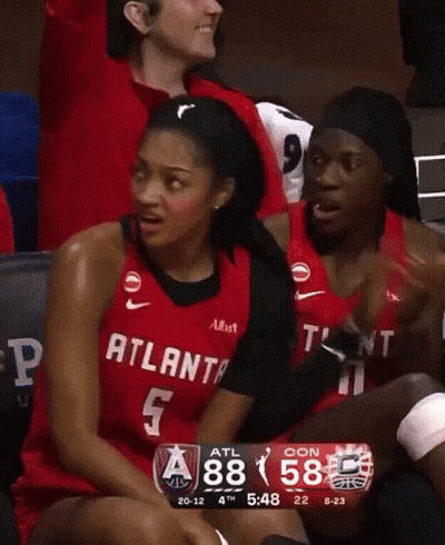 Woman In Red Atlanta Jersey Sitting On Bench GIF
