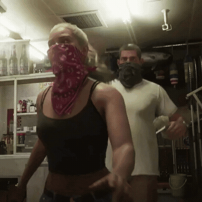 Woman In Red Bandana Next To Man GIF