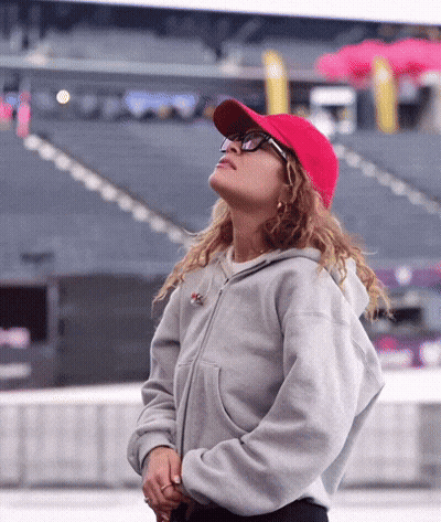 Woman In Red Baseball Cap And Glasses Looking Up GIF