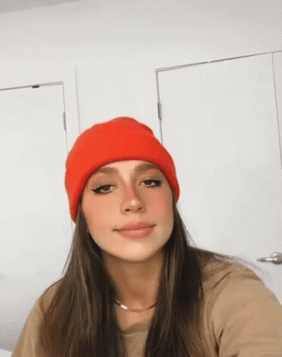 Woman In Red Beanie Taking Selfie In Front Of Door GIF