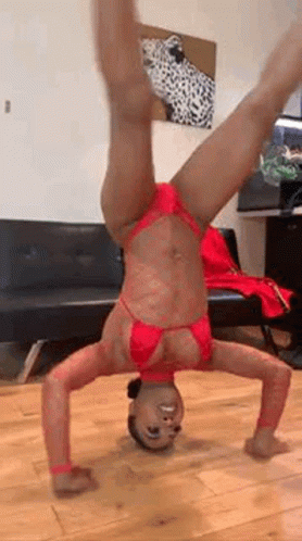 Woman In Red Bikini Doing Handstand In Living Room GIF