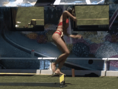 Woman In Red Bikini Jumping Over Yellow Barrier GIF