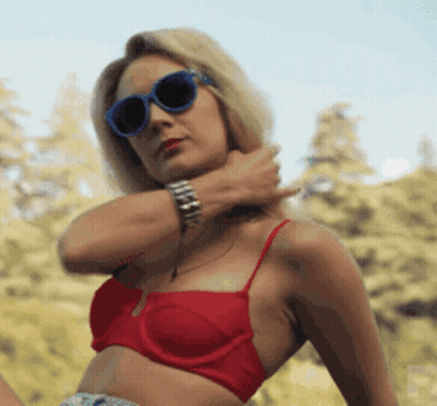 Woman In Red Bikini Top And Blue Sunglasses Holding Neck GIF