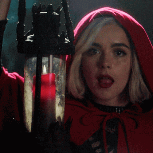 Woman In Red Cape Holding Candle GIF