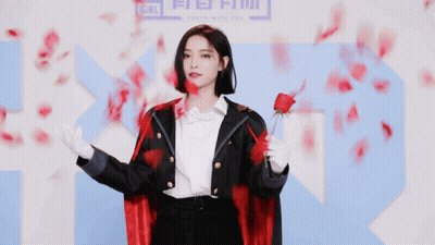 Woman In Red Cape Holding Rose By Sign Saying Girl GIF