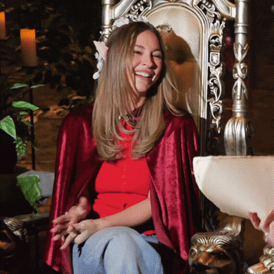 Woman In Red Cape Sitting On Throne GIF