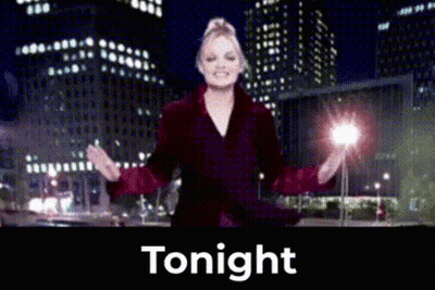 Woman In Red Coat Standing Before Tonight Sign GIF