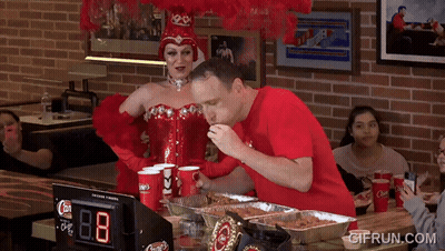 Woman In Red Corset And Man In Red Shirt Eating Pizza GIF