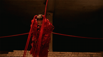 Woman In Red Costume Tied Up With Red Ropes GIF