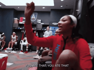 Woman In Red Dream Shirt Sitting In Locker Room GIF