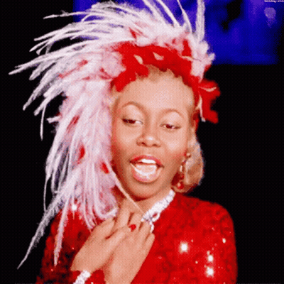 Woman In Red Dress And Feathered Headpiece GIF