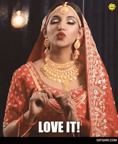 Woman In Red Dress And Gold Jewelry Saying Love It GIF