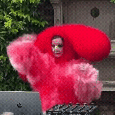 Woman In Red Dress And Hat Dancing In Front Of Laptop GIF