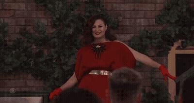 Woman In Red Dress And Red Gloves Smiling GIF