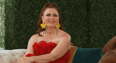 Woman In Red Dress And Yellow Earrings On Chair GIF