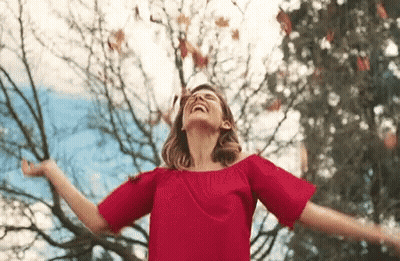 Woman In Red Dress Arms Outstretched GIF