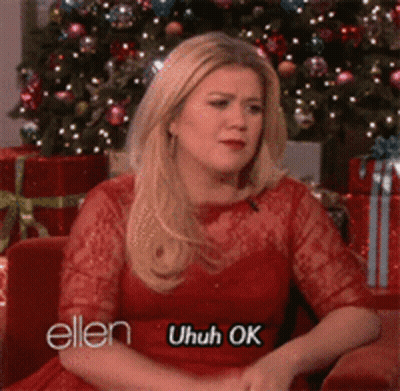 Woman In Red Dress By Christmas Tree Saying Uhuh Ok GIF