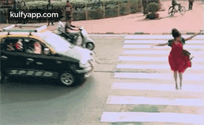 Woman In Red Dress Crossing Street GIF