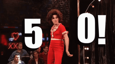 Woman In Red Dress Dancing In Front Of 5 0 Sign GIF